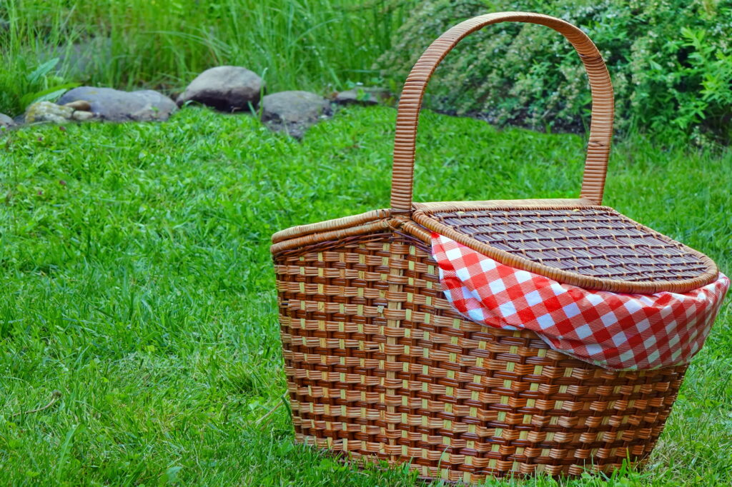 Picnic Basket On The Fresh Summer Lawn