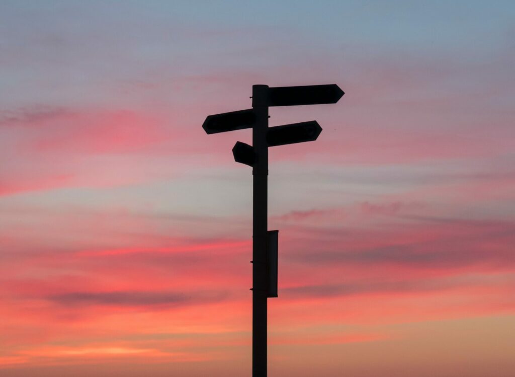 pick a direction sign at sunset - facts or feelings