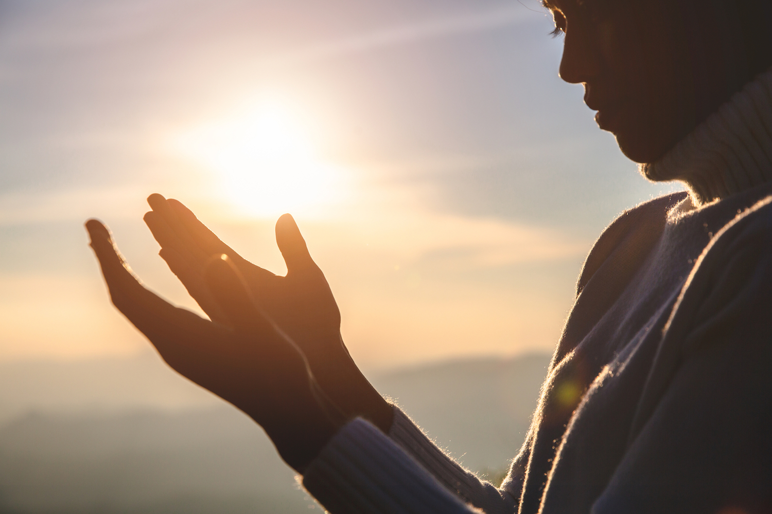 Spiritual Agility - woman holding hands up into the light of the sun