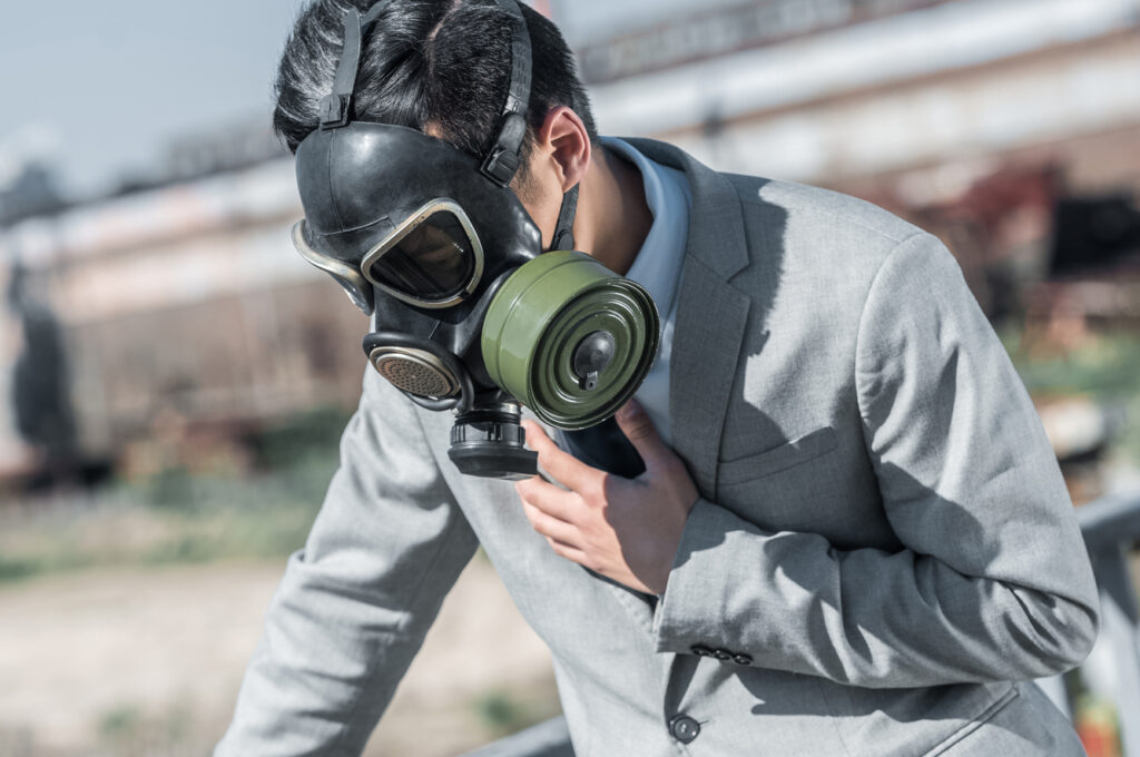 Business man wearing a gas mask - toxic
