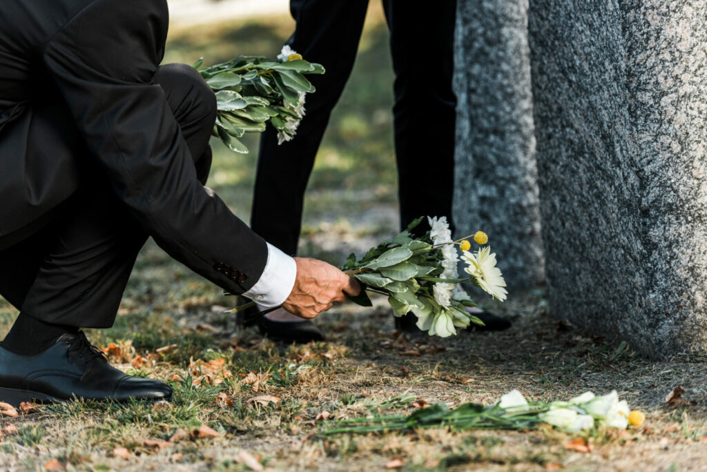 flowers being placed in a graveyard
