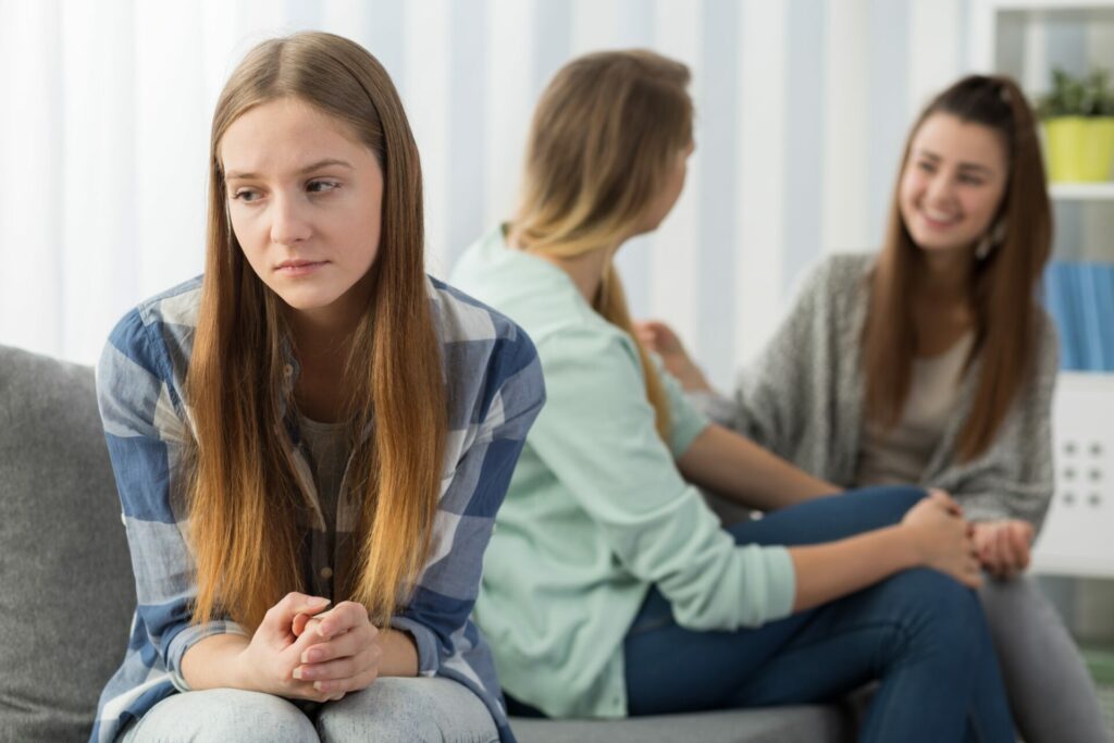 Sad teen girl left out of the conversation